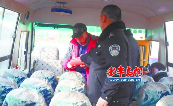 工作人員在檢查校車上的消防設施。